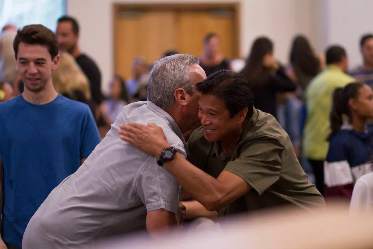 two men hugging construction networking